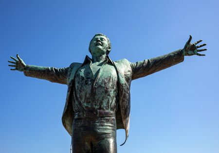 Polignano a Mare, Italy - Sept 17, 2019: Statue of the Italian singer and songwriter Domenico Modugno famous for the song Volare was born in Polignano a Mare. Italy. The author of the sculpture is Herman Mejerのeditorial素材