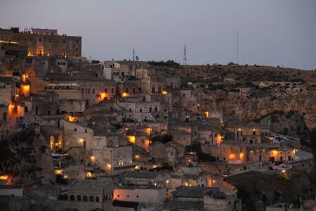 Amazing lighted buildings in ancient Sassi district by night in Matera, well-known for their ancient cave dwellings. Basilicata. Italyの写真素材