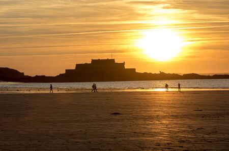 St Malo, France - September 15, 2018: Romantic walk of people before sunset on the picturesque beach of Saint Malo. Brittany, Franceのeditorial素材