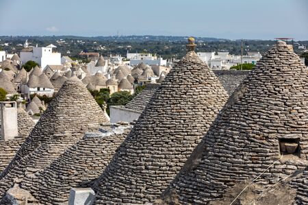 Stone roofs of Trulli Houses in Alberobello; Italy. The style of construction is specific to the Murge area of the Italian region of Apulia (in Italian Puglia). Made of limestone and keystone.の写真素材