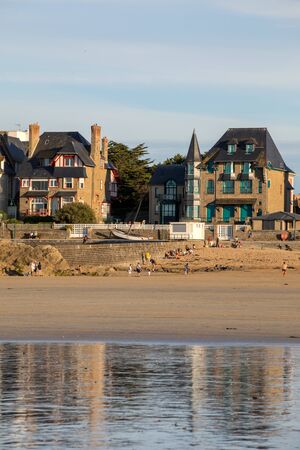 St Malo, France - September 16, 2018: Beach in the evening sun and buildings along the seafront promenade in Saint Malo. Brittany, Franceのeditorial素材