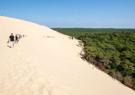 Dune of Pilat; France - September 10; 2018: People walking on the top of the Dune of Pilat; the tallest sand dune in Europe. La Teste-de-Buch; Arcachon Bay; Aquitaine; Franceのeditorial素材