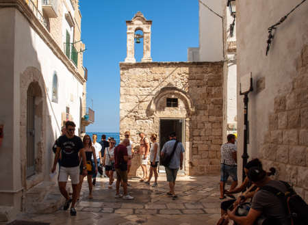 Polignano a Mare, Italy - September 17, 2019:  People walking on the charming and romantic historic...