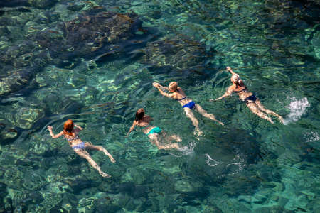 Polignano a Mare, Italy - September 17, 2019: People relax and swimming on lovely beach Lama Monachile in Polignano a Mare, Adriatic Sea, Apulia, Bari province, Italy,のeditorial素材