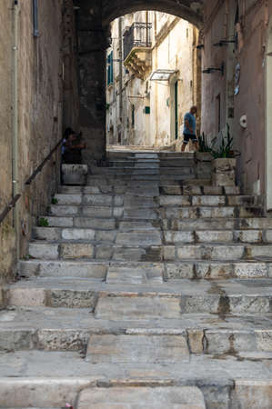 Matera, Italy - September 15, 2019: Typical cobbled stairs in a side street alleyway iin the Sassi di Matera a historic district in the city of Matera. Basilicata. Italyのeditorial素材