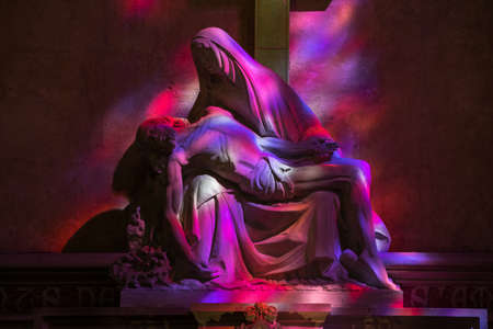 St Emilion, France - September 8, 2018: Pieta in Hues of Purple and red - symbolic reference to the color of the wine in the Collegiale church of St Emilion, Franceのeditorial素材