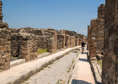 Pompeii, Italy - June 15, 2017: An ancient cobbled street in the ruins of Pompeii, Italy. Roman town destroyed by Vesuvius volcano.のeditorial素材