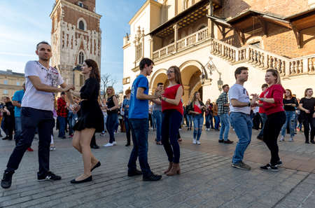 Cracow, Poland - March 30, 2019:  International Flashmob Day of Rueda de Casino. Several hundred persons dance Hispanic rhythms on the Main Square in Cracow. Polandのeditorial素材