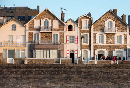 St Malo, France - September 15, 2018: Beach in the evening sun and buildings along the seafront promenade in Saint Malo. Brittany, Franceのeditorial素材