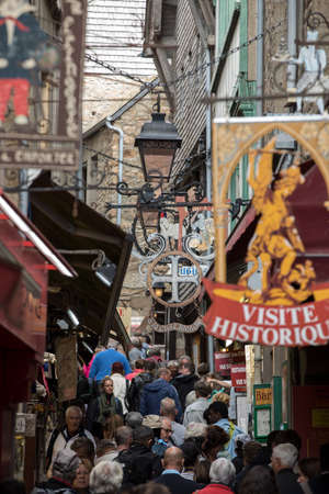 Le Mont-Saint-Michel, France - September 13, 2018: A crowd of tourists on Grand Rue, the main street in Mont Saint Michele. Normandy, Franceのeditorial素材