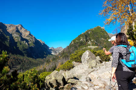 Vysoke Tatry, Slovakia - October 10, 2018: Hikers on trail at Great Cold Valley, Vysoke Tatry (High Tatras), Slovakia. The Great Cold Valley is 7 km long valley, very attractive for touristsのeditorial素材