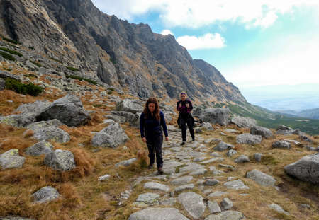 Vysoke Tatry, Slovakia - October 10, 2018: Hikers on trail at Great Cold Valley, Vysoke Tatry (High Tatras), Slovakia. The Great Cold Valley is 7 km long valley, very attractive for touristsのeditorial素材