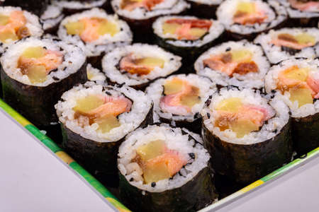 Top view of stack of Japanese sushi maki roll plate. Served in Japanese bar restaurant with chopstickの写真素材