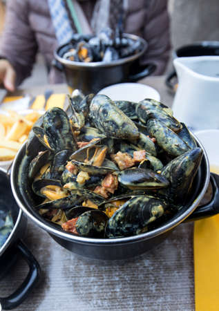 Tasty black mussels in sauce. Saint Malo, Brittany, France