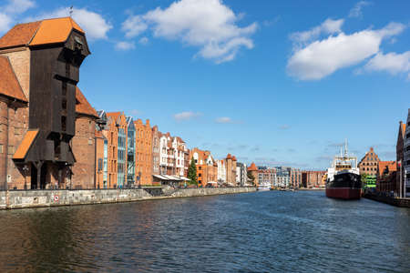 Gdansk, Poland - Sept 9, 2020: The largest medieval port Crane in Europe and historic buildings on...