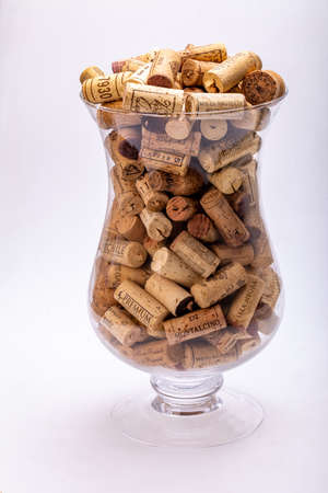 Ochojno, Pioland - December 24, 2020: Collection of used wine corks in a glass vase. Decorative decoration of the interior of a restaurant, bar or home.のeditorial素材