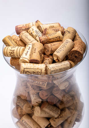 Ochojno, Pioland - December 24, 2020: Collection of used wine corks in a glass vase. Decorative decoration of the interior of a restaurant, bar or home.のeditorial素材