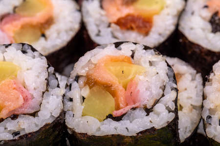 Top view of stack of Japanese sushi maki roll plate. Served in Japanese bar restaurant with chopstickの写真素材