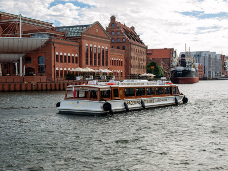 Gdansk, Poland - September 9, 2020: Tourist cruise ship on Motlawa river in historical Old Town of...
