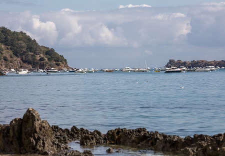 Cancale, France - September 15, 2018: Fishing boats and yachts moored in the bay at high tide in Cancale, famous oysters production town. Brittany, france,のeditorial素材