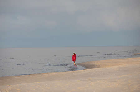 Stegna, Poland - September 4, 2020: A woman during a relaxing walk on an empty beach in Stegnyのeditorial素材