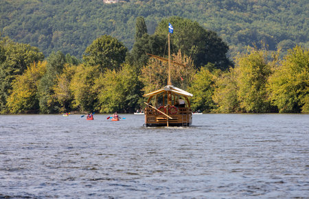 La Roque-Gageac, Dordogne, France - September 7, 2018: Canoeing and tourist boat, in French called gabare, on the river Dordogne at La Roque-Gageac, Aquitaine, Franceのeditorial素材