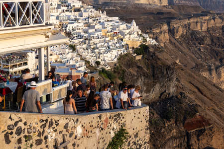 Fira, Santorini, Greece - June 27, 2021: The whitewashed town of Fira in warm rays of sunset on Santorini island, Cyclades, Greeceのeditorial素材