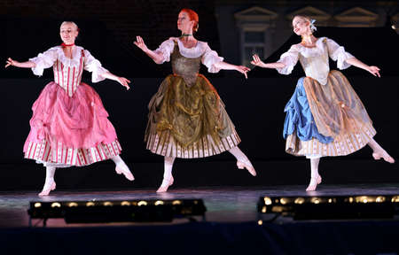 Krakow, Poland - July 25, 2021: Artists in costumes performing on stage during a show of court...