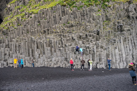 Reynisfjara, Iceland - July 21, 2017: Column of basalt stone in the black sand beach of Reynisfjara in the southern coast of Icelandのeditorial素材