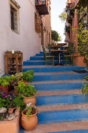 Small narrow street with blue stairs in Old Town of Rethymnon, Crete island, Greeceの写真素材
