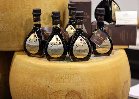 Cracow, Poland - November 5, 2021: Whole wheel of Parmigiano Reggiano cheese and balsamic vinegar at Enoexpo and Gastrofood - Trade Fair for Food and Drinks for Cateringのeditorial素材