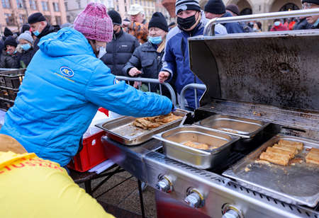 Krakow, Poland - Dec 19, 2021: Christmas Eve for poor and homeless on the Main Square in Cracow. Despite the Covid pandemic, the group Kosciuszko prepares the greatest eve in the open air in Krakowのeditorial素材