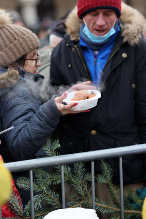 Krakow, Poland - Dec 19, 2021: Christmas Eve for poor and homeless on the Main Square in Cracow. Despite the pandemic, the group Kosciuszko prepares the greatest eve in the open air in Krakowのeditorial素材