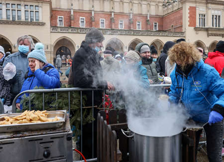 Krakow, Poland - Dec 19, 2021: Christmas Eve for poor and homeless on the Main Square in Cracow. Despite the pandemic, the group Kosciuszko prepares the greatest eve in the open air in Krakowのeditorial素材
