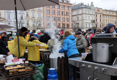 Krakow, Poland - Dec 19, 2021: Christmas Eve for poor and homeless on the Main Square in Cracow. Despite the pandemic, the group Kosciuszko prepares the greatest eve in the open air in Krakowのeditorial素材