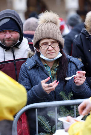 Krakow, Poland - Dec 19, 2021: Christmas Eve for poor and homeless on the Main Square in Cracow. Despite the Covid pandemic, the group Kosciuszko prepares the greatest eve in the open air in Krakowのeditorial素材