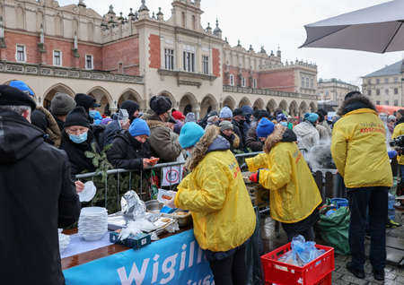 Krakow, Poland - Dec 19, 2021: Christmas Eve for poor and homeless on the Main Square in Cracow. Despite the Covid pandemic, the group Kosciuszko prepares the greatest eve in the open air in Krakowのeditorial素材