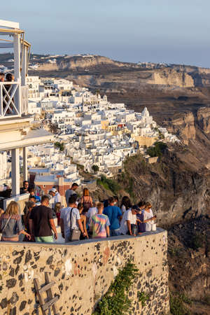Fira, Santorini, Greece - June 27, 2021: The whitewashed town of Fira in warm rays of sunset on Santorini island, Cyclades, Greeceのeditorial素材