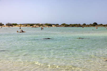 Elafonisi, Crete, Greece - Sept 19, 2021: People relaxing on the famous pink coral beach of Elafonisi on Crete, Mediterannean sea, Greeceのeditorial素材