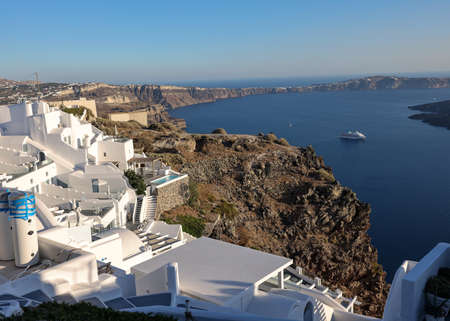 Imerovigli, Santorini, Greece - June 29, 2021: Whitewashed houses with terraces and pools and a beautiful view in Imerovigli on Santorini island, Greeceのeditorial素材