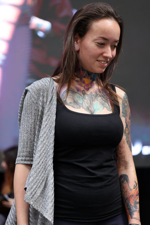 Krakow, Poland - June 12, 2022: Unidentified participant during the contest for the best tattoo at the 15th Tattoofest Convention in Cracow. One of the most prestigious tattoo festivals.のeditorial素材