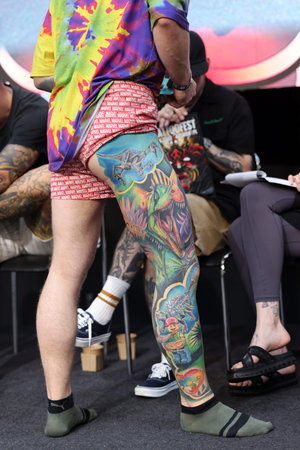 Krakow, Poland - June 12, 2022: Unidentified participant during the contest for the best tattoo at the 15th Tattoofest Convention in Cracow. One of the most prestigious tattoo festivals.のeditorial素材