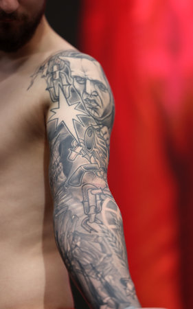 Krakow, Poland - June 11, 2022: Unidentified participant during the contest for the best tattoo at the 15th Tattoofest Convention in Cracow. One of the most prestigious tattoo festivals.のeditorial素材