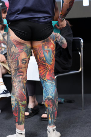 Krakow, Poland - June 12, 2022: Unidentified participant during the contest for the best tattoo at the 15th Tattoofest Convention in Cracow. One of the most prestigious tattoo festivals.のeditorial素材