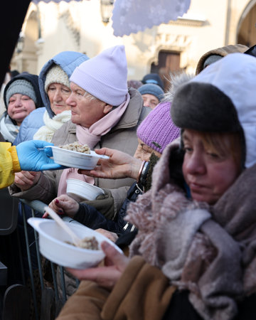 Krakow, Poland - Dec 18, 2022: Christmas Eve for poor and homeless on the Main Square in Cracow. The...