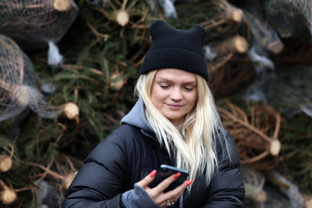 Krakow, Poland - Dec 19, 2021: Margaret during the distribution of Christmas trees at Szczepanski Square in Krakowのeditorial素材