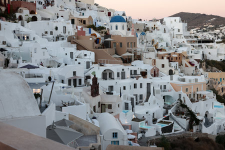 Oia, Santorini, Greece - June 28, 2021: Whitewashed houses with terraces and pools and a beautiful view in Oia on Santorini island, Greeceのeditorial素材