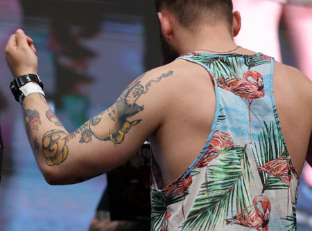 Krakow, Poland - June 11, 2022: Unidentified participant during the contest for the best tattoo at the 15th Tattoofest Convention in Cracow. One of the most prestigious tattoo festivals.のeditorial素材