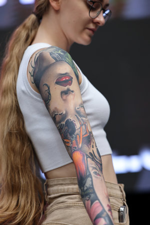 Krakow, Poland - June 12, 2022: Unidentified participant during the contest for the best tattoo at the 15th Tattoofest Convention in Cracow. One of the most prestigious tattoo festivals.のeditorial素材