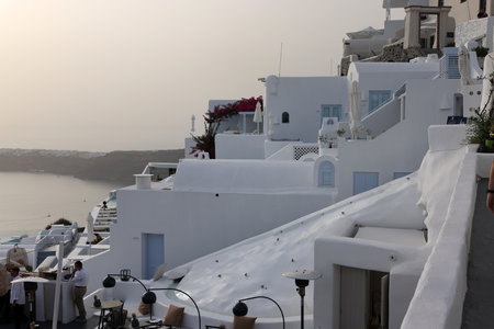 Imerovigli, Santorini, Greece - July 1, 2021: Whitewashed houses with terraces and pools and a beautiful view in Imerovigli on Santorini island, Greeceのeditorial素材